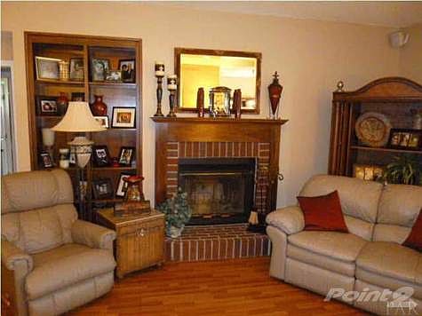 Wood burning fireplace with brick front and hearth in the Great Room