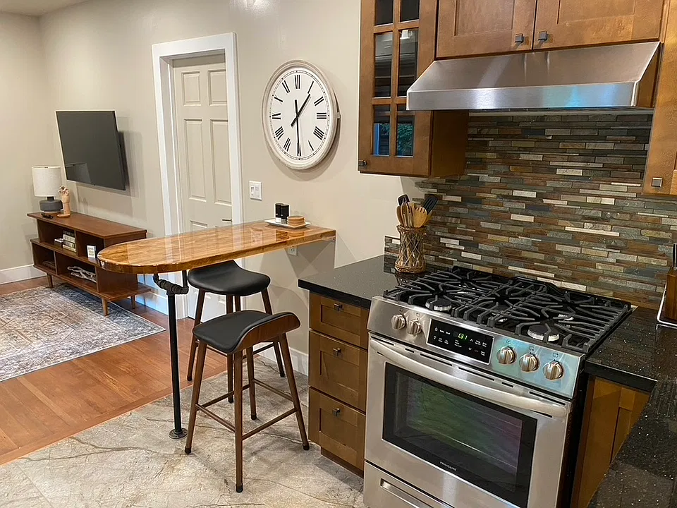 Kitchen table with two bar stools.
Door to bedroom