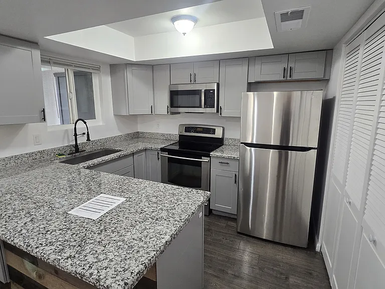 Updated kitchen with newer cabinets and granite countertops.