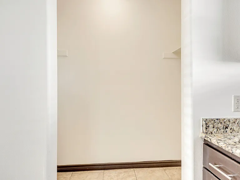 Kitchen interior showcasing a granite countertop and cabinets at La Joya Apartments in Laredo, Texas