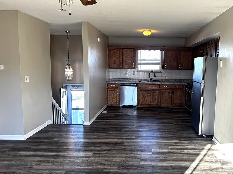 LOOKING AT ENTRY-KITCHEN AND LIVING AREA