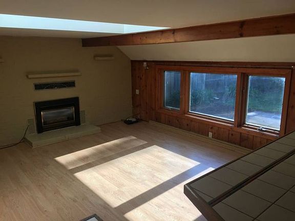 Large family room with a lot of natural light and gas fireplace