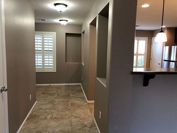 Foyer and Hallway to Kitchen- Breakfast Bar on right.