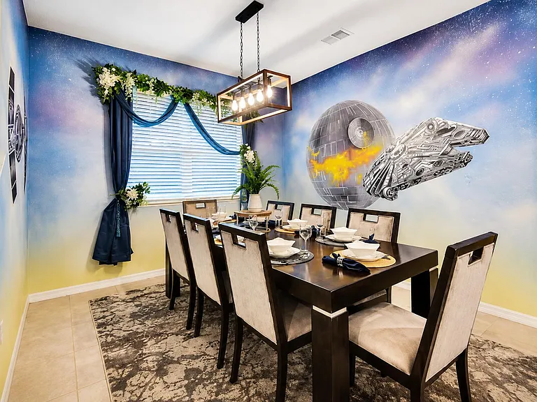 Dedicated dining area with a full-size table for six, overhead pendant lighting, and a window with blinds for natural light.