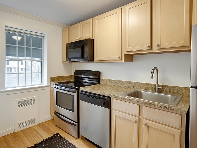This beautiful kitchen is equipped with a stove and microwave