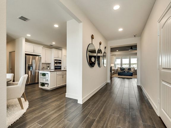 Entryway into home with views of dining and kitchen areas