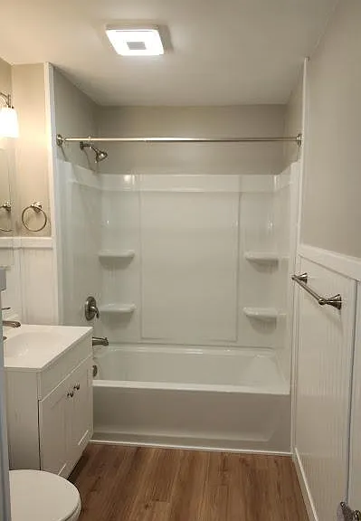 New Upstairs Bath, wainscoting, new tub/shower, Wi-Fi ceiling fan, new base & medicine cabinets, sink, faucet, toilet, lighting, luxury vinyl flooring.