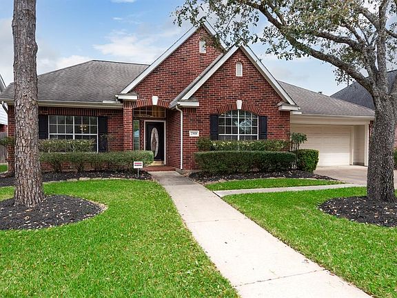 The beautiful red brick and dark shutters add to the majestic curb appeal of the home.