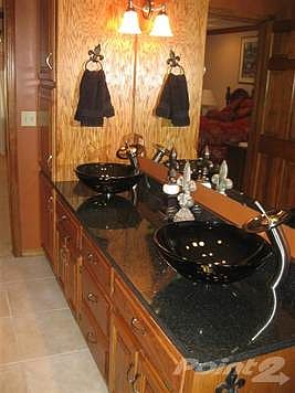 Another view of updated master bath with double vanity and built in linene