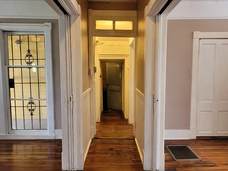 View down the main hall from between parlor pocket doors to laundry room (before exterior repainted)