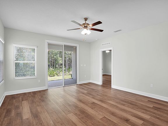 The family room has a sliding door that opens up to the back patio