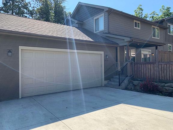 Garage with front entry and yard.