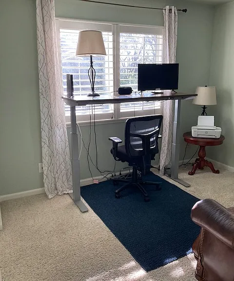Office-with desk that can be lowered or raised so that you can stand or sit while working.