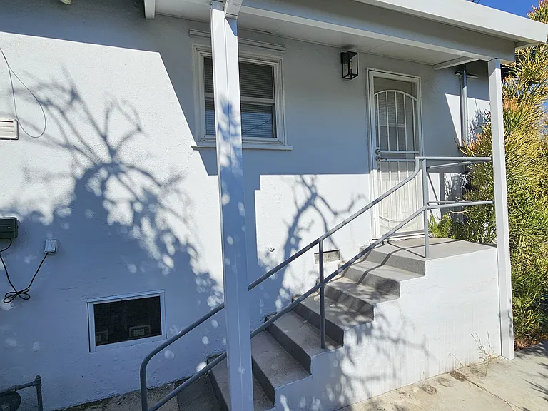 Outside of rear door. Stairs lead to outside rear area.