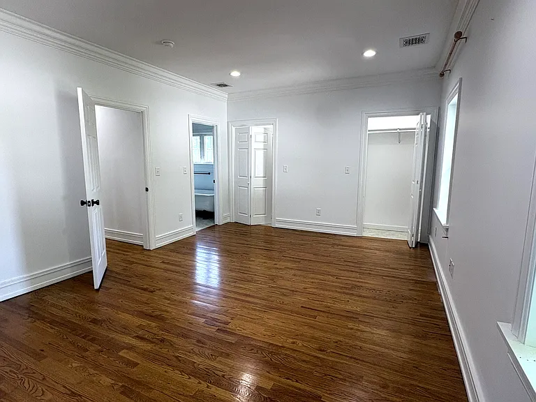 2nd Fl - EnSuite Primary Bedroom with Primary Bath and Hallway (l) and Double Lighted Closets (c)
