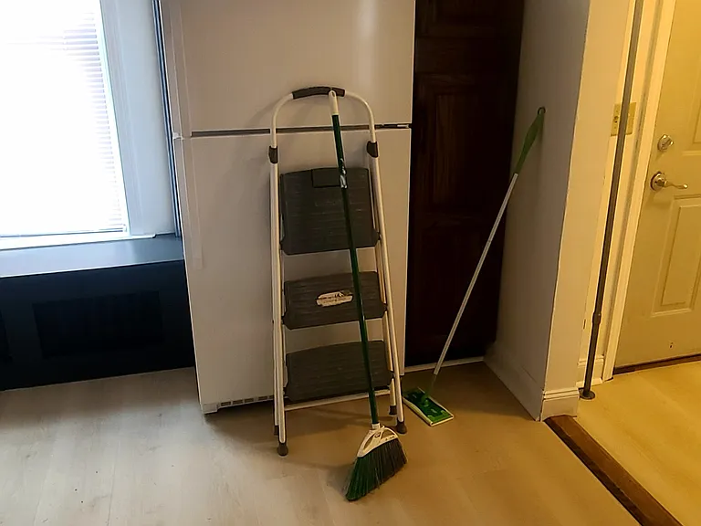 fridge with shelves cabinet next to it