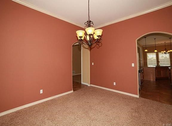 Formal dining with door to entry on left and door to kitchen on right.