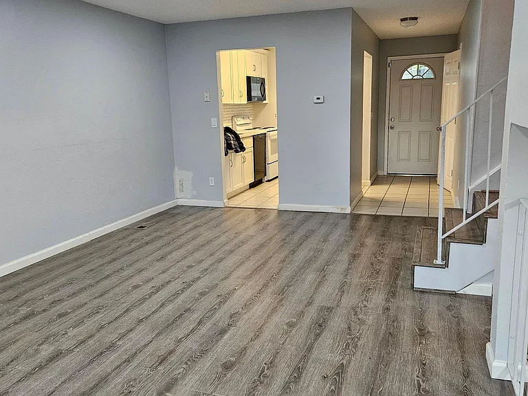Living room plus dining room, stairs to bedrooms
