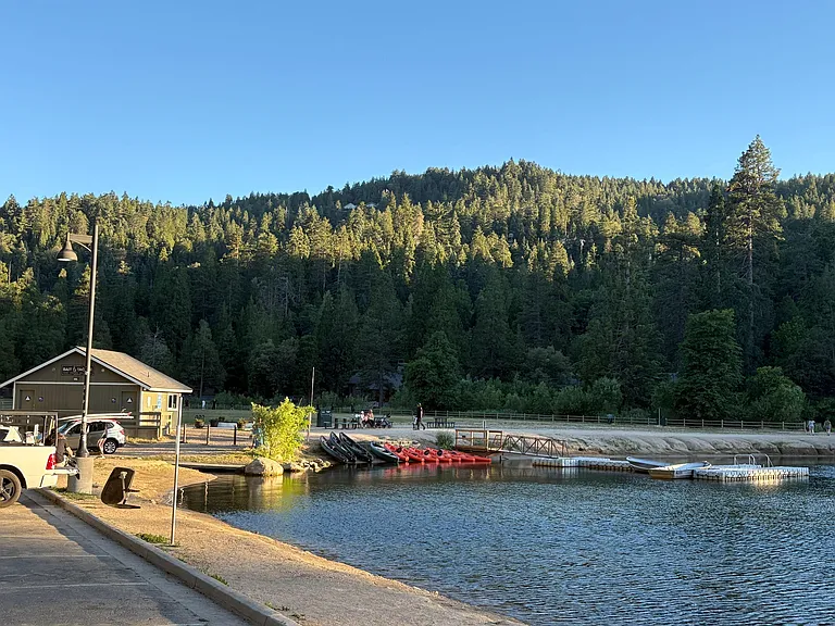 Lakeside setting with shoreline access and scenic forested hillside views. Ideal for outdoor relaxation near the water.