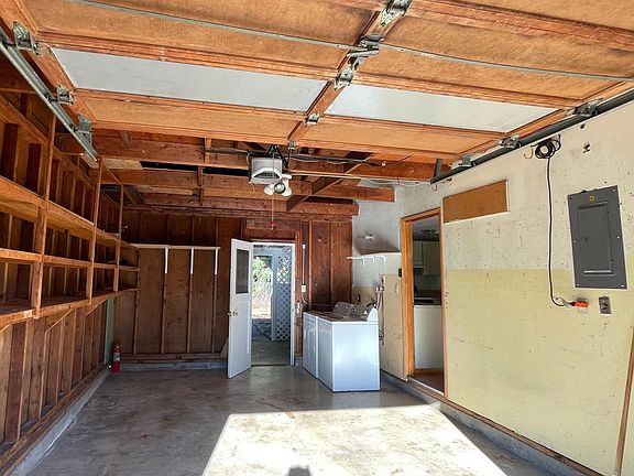 single car garage with storage and washer/dryer.