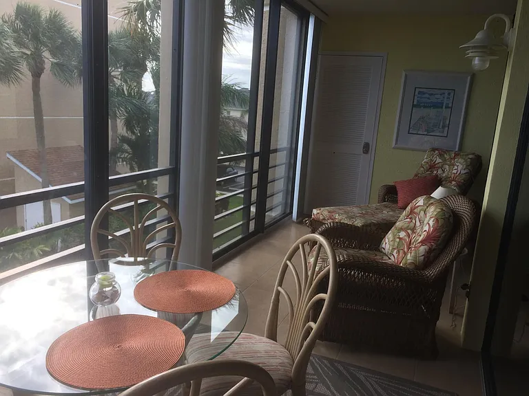 A serene Balcony offering stunning views of the Florida palm trees.