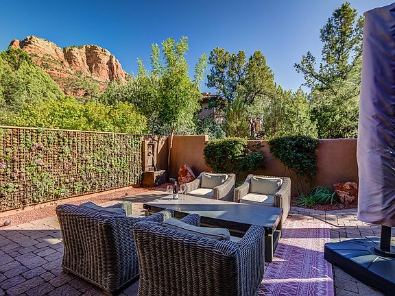 Back patio with two water features, comfortable furnishings and amazing red rock views