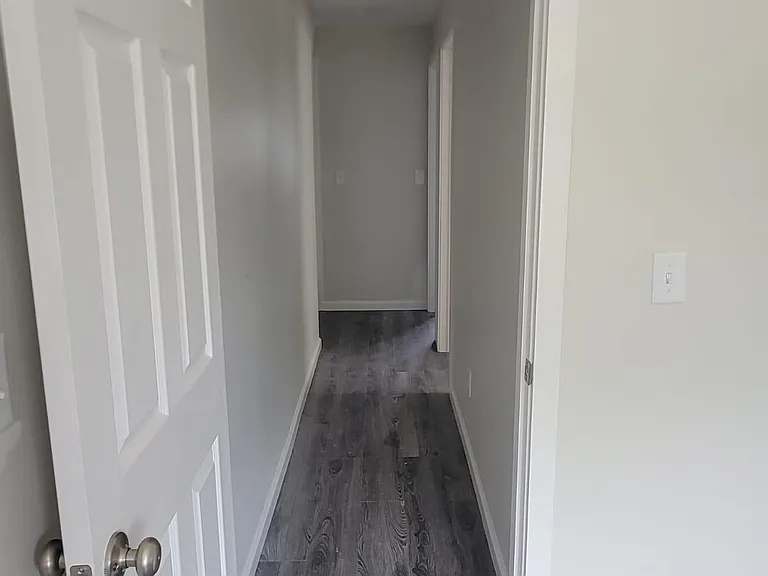 Second floor hallway connects three upstairs bedrooms.