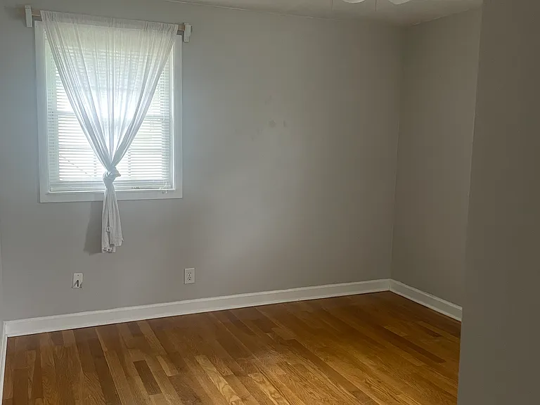 Alternate view of front room. Two windows.