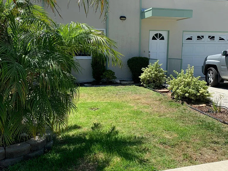 front unit #1 grass front yard, 2 car parking in left side of garage & tandem