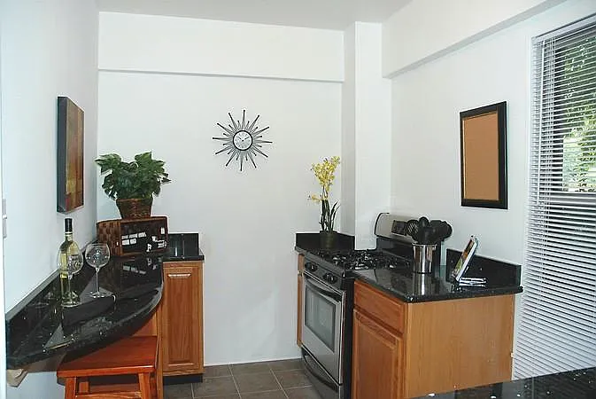 Kitchen partial view, sink and dishwasher in foreground