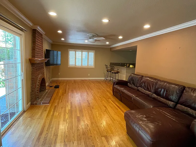 Family room with hardwood floor and gas fireplace.