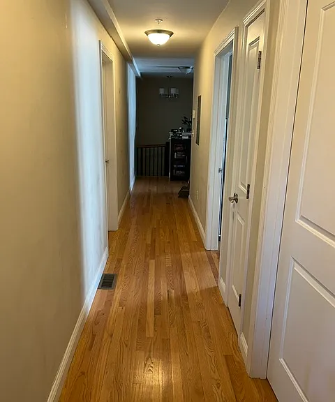 Hallway from back entrance to kitchen/living room. The spiral staircase that leads to the lower level master suite is at the end of the hallway.