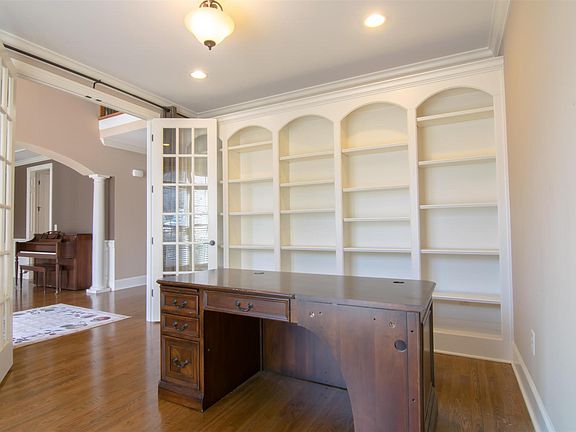 Office with built-in shelving and French Doors