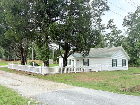 Charming country home for rent near beautiful Lake Moultrie. The unfinished home offers comfortable living space and a peaceful rural setting perfect for those seeking quiet country living.