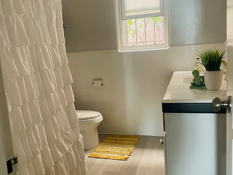 Spacious full bathroom with a tub and lots of sunlight