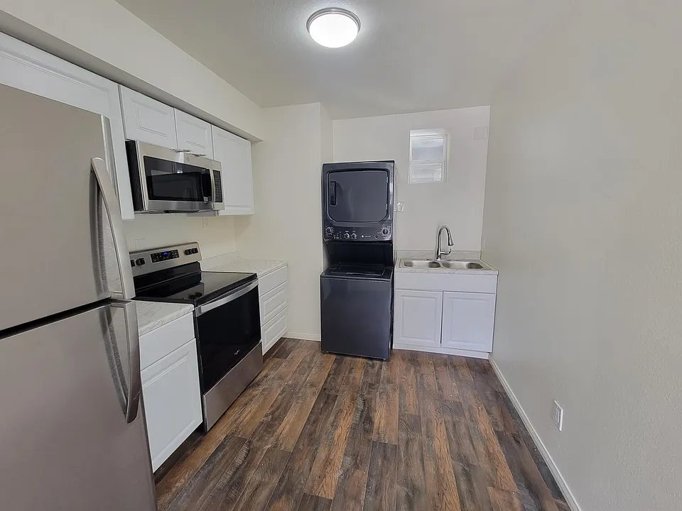 full Kitchen with Refrigerator and a stackable washer and dryer for your convenience inside the unit.