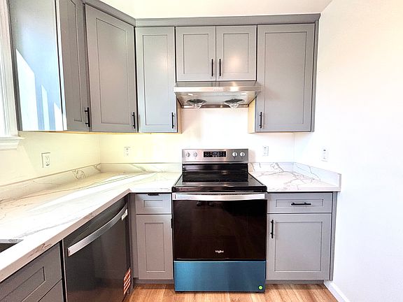 BRAND-NEW kitchen with stainless-steel appliances and flooring.