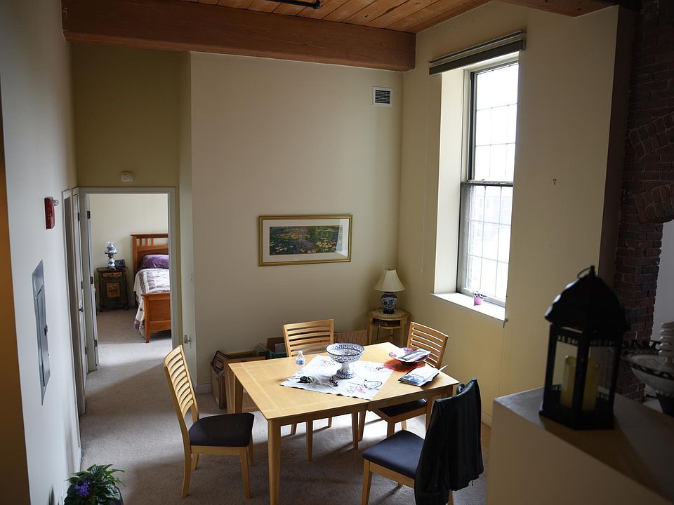 The dining area with the bedroom in the background