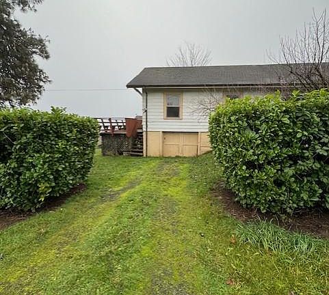view of unfinished basement door and more parking