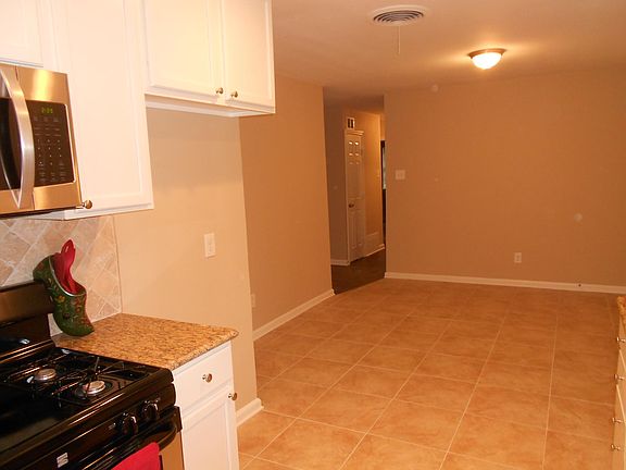 Kitchen Looking Back Across Dining Area to Bedroom Hallway