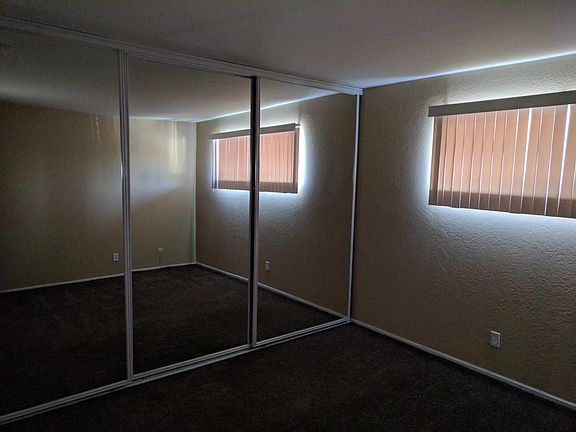 Master bedroom with reflective sliding doors