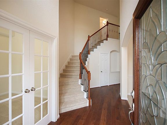 Gorgeous wrought iron staircase with a large storage closet under the staircase.