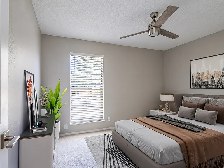 Renovated bedroom with plush grey carpeting