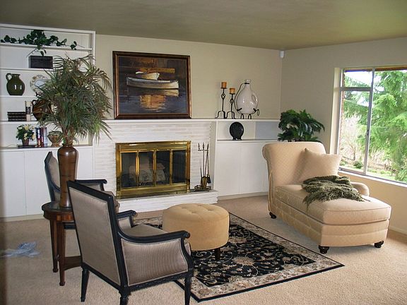 The living room has a firepl and great western views.