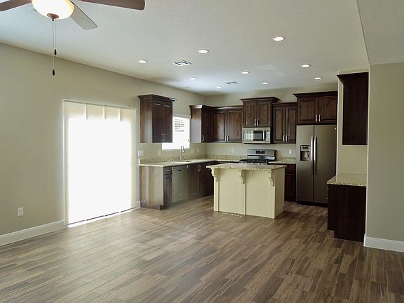 A sliding glass door opens to a large enclosed patio adjoining the common area.