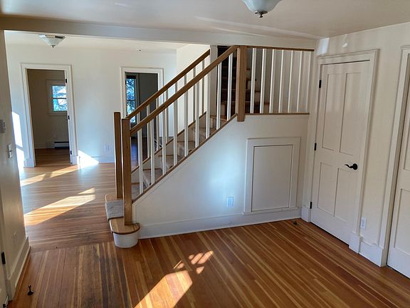 View from dining room towards living room, with stairs to upper loft bedroom.