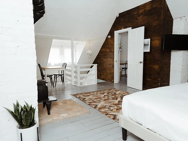 huge upstairs bedroom with soaring 26ft ceiling and wood burning fireplace