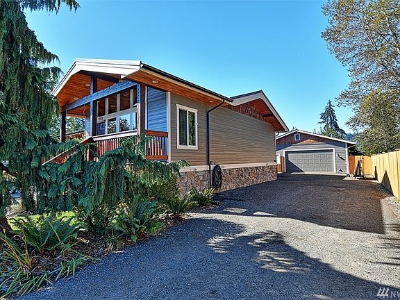Side of main house, plenty of parking in the driveway and 30' X 50' garage shop with apartment attached.