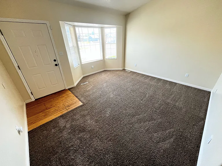Cozy front living room just beyond the front door, perfect for relaxing or entertaining guests.