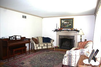Living Room features woodburning fireplace and crown molding.